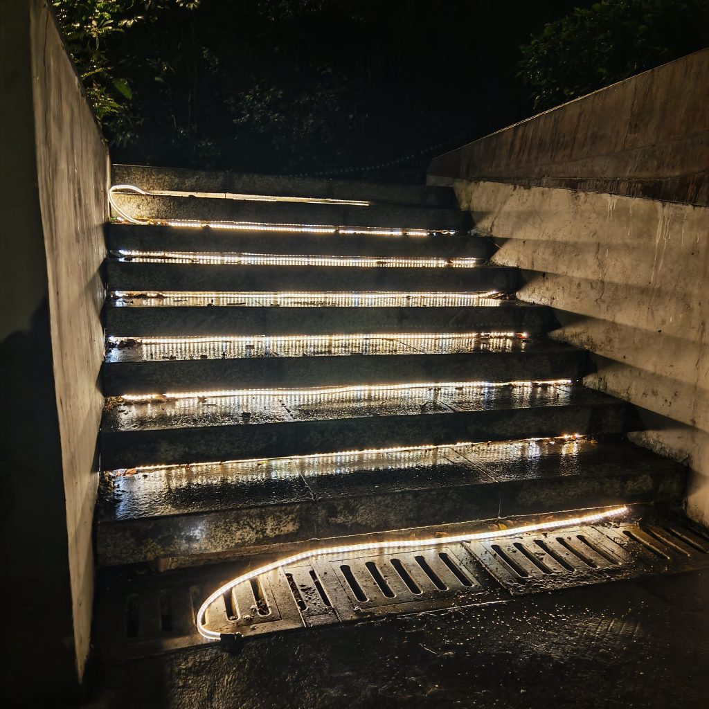 Bare waterproof LED strip falling off outdoor stone stairs due to adhesive failure