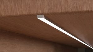 Recessed and surface-mount LED aluminum profiles compared on a cabinet panel