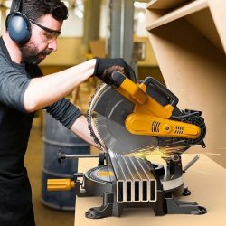 Contractor using a miter saw on-site to cut LED aluminum extrusions and diffusers together for clean edges.