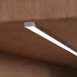 Recessed and surface-mount LED aluminum profiles compared on a cabinet panel